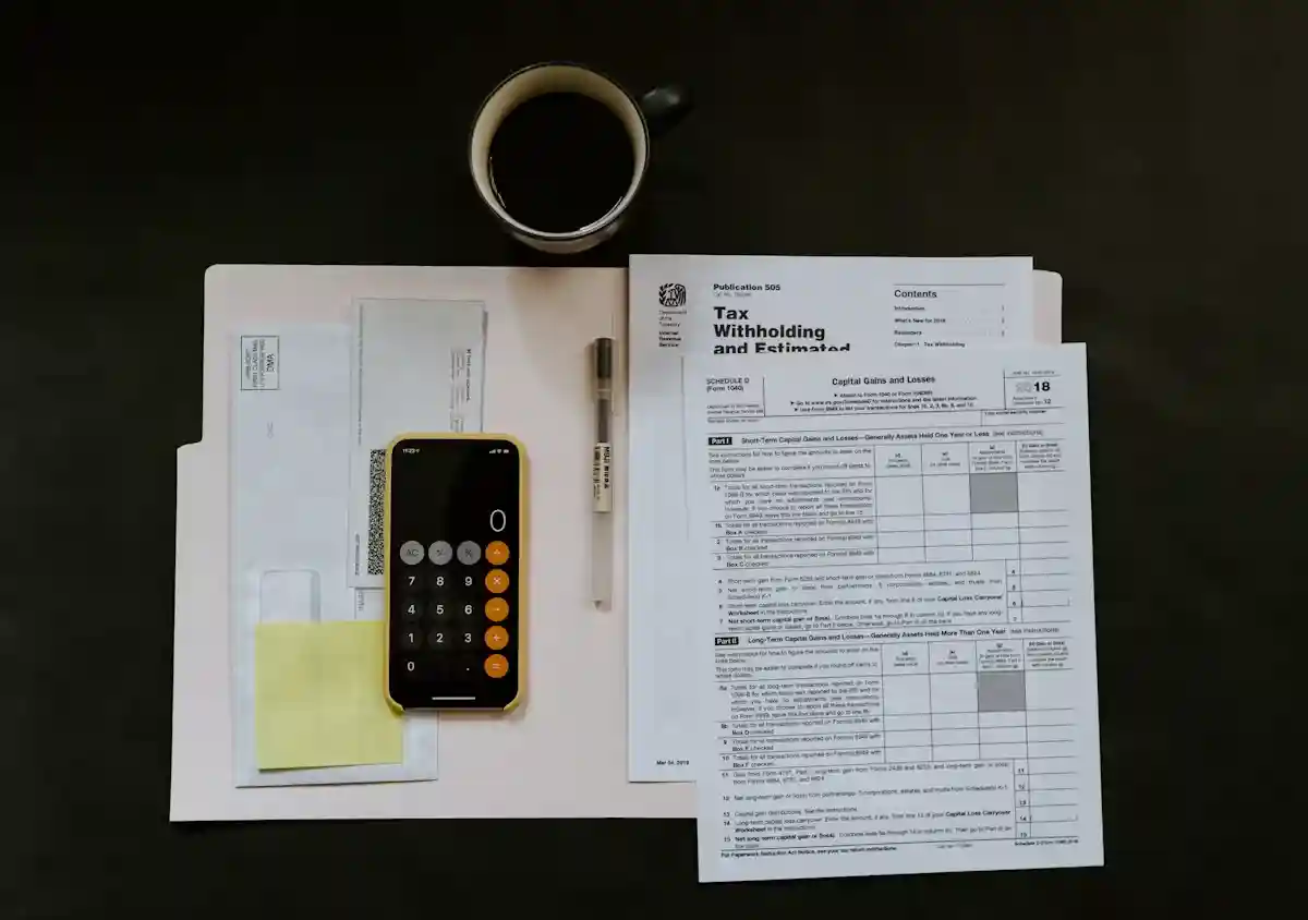 Person reviewing financial documents and a calculator