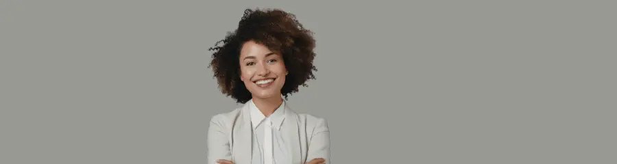Confident smiling woman with arms crossed, portrait for employers building team capability.