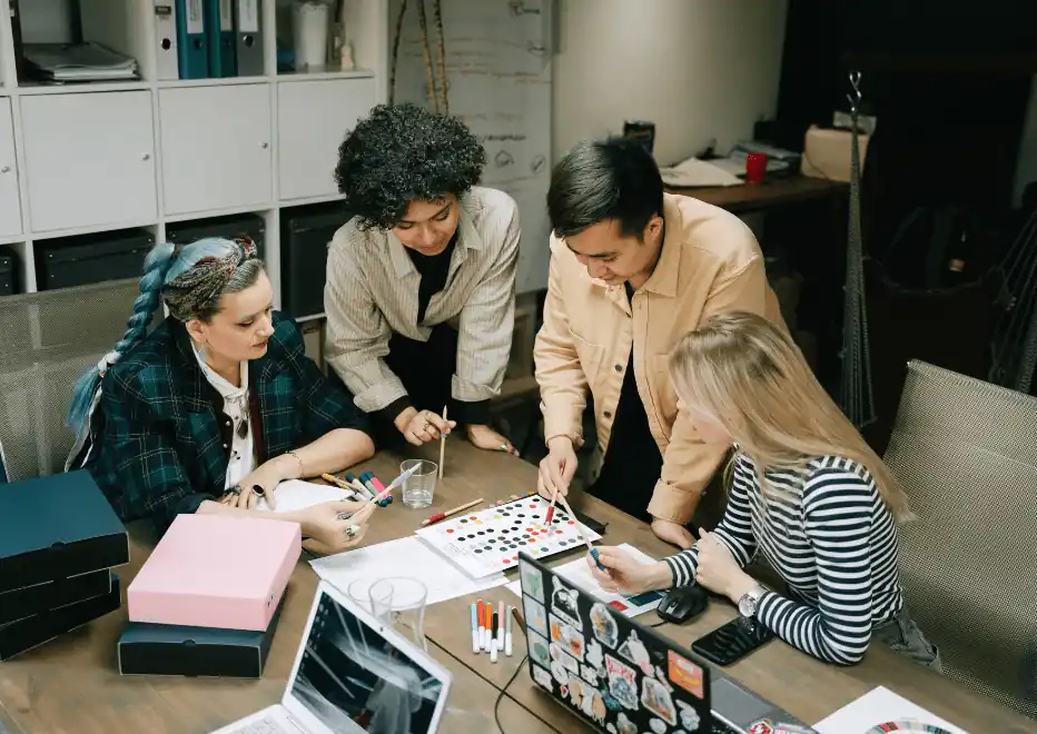 Creative team reviewing brand color and design materials together.